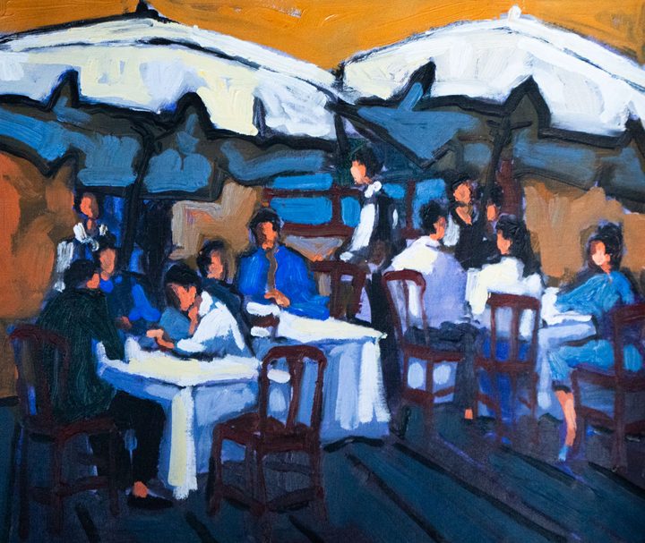 Diners under white umbrellas